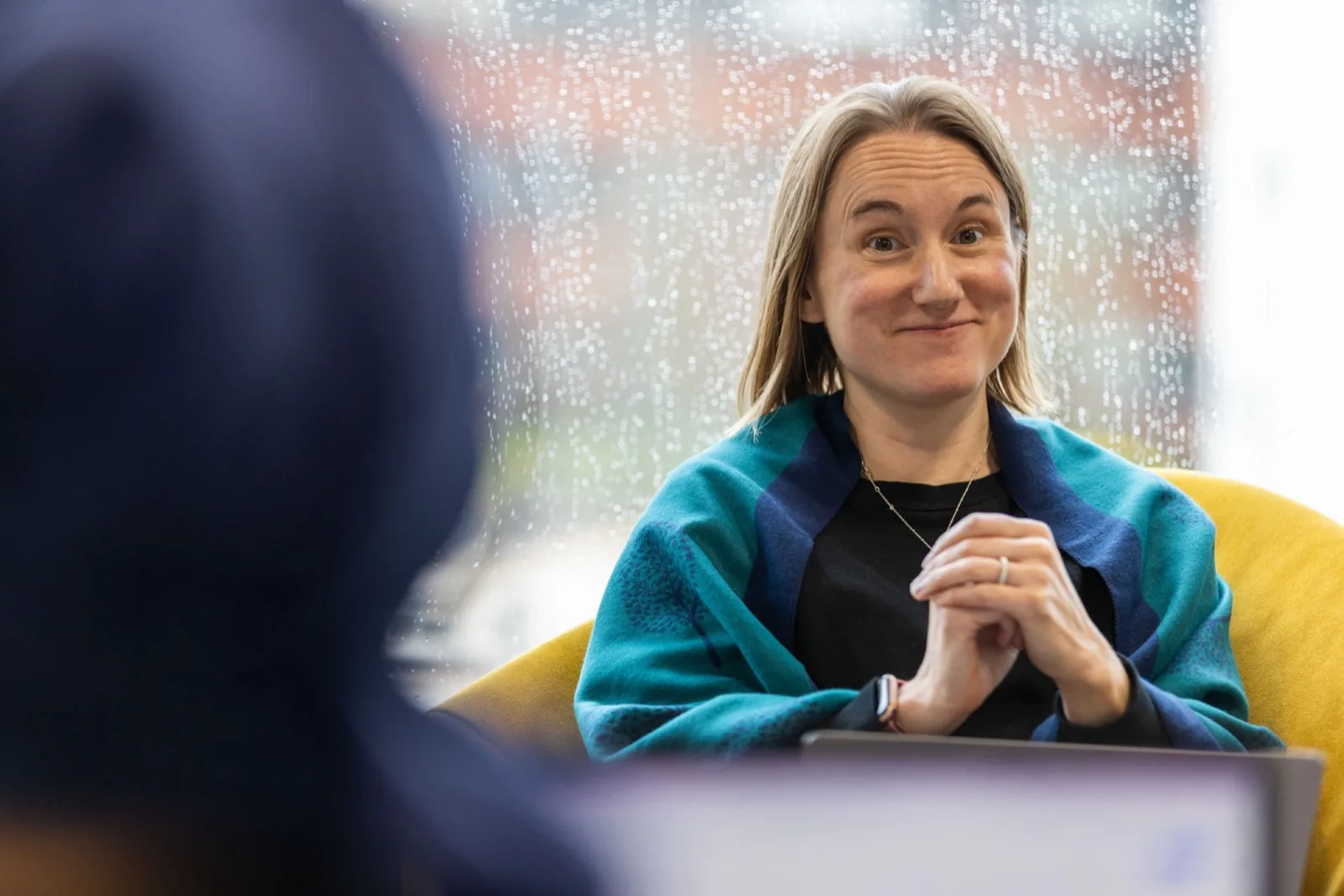 Becky, PortSwigger's Head of Culture, smiling warmly with an approachable, eyebrows-raised expression